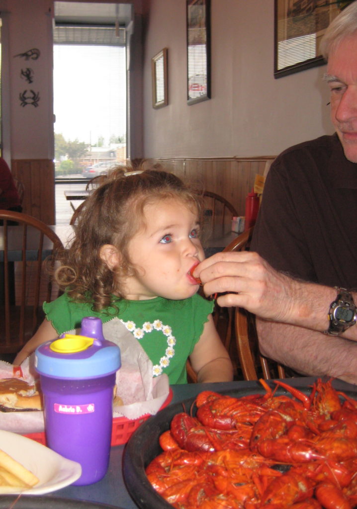 Aubrie learns to eat crawfish!  That's my New Orleans girl!